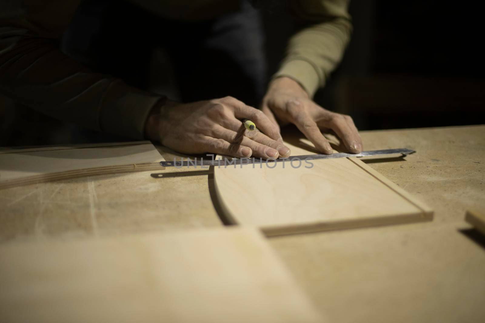 Marking on ruler with pencil. Drawing line on tree. Hands of carpenter. by OlegKopyov