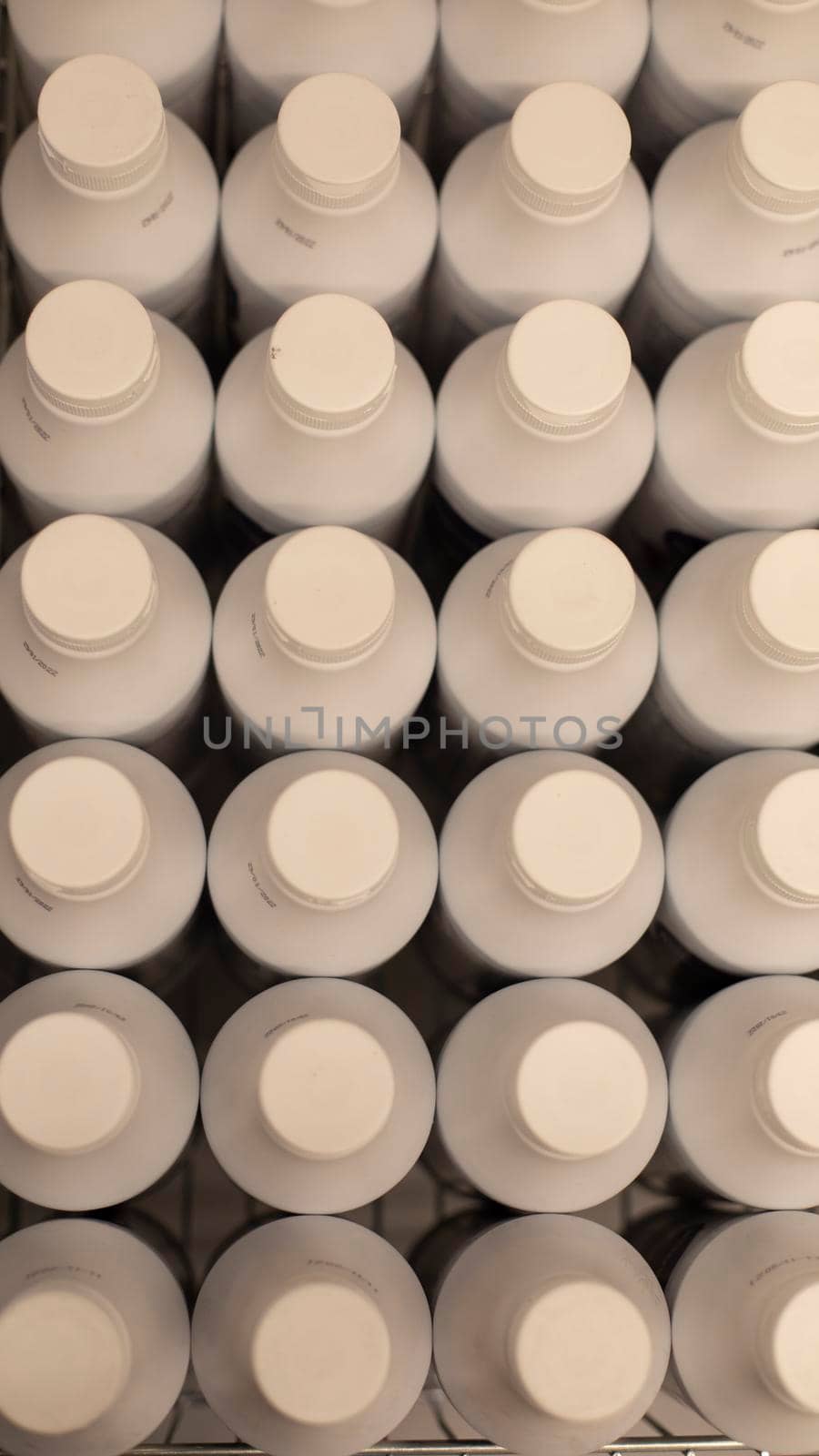 White plastic bottles top view. Lots of milk bottles. Texture from beverage containers.