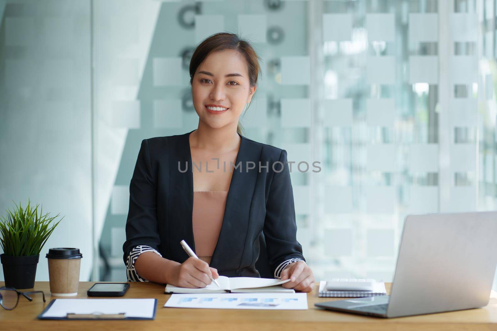 Portrait of Business woman hand holding pen and analyze financial. Account and Finance concept