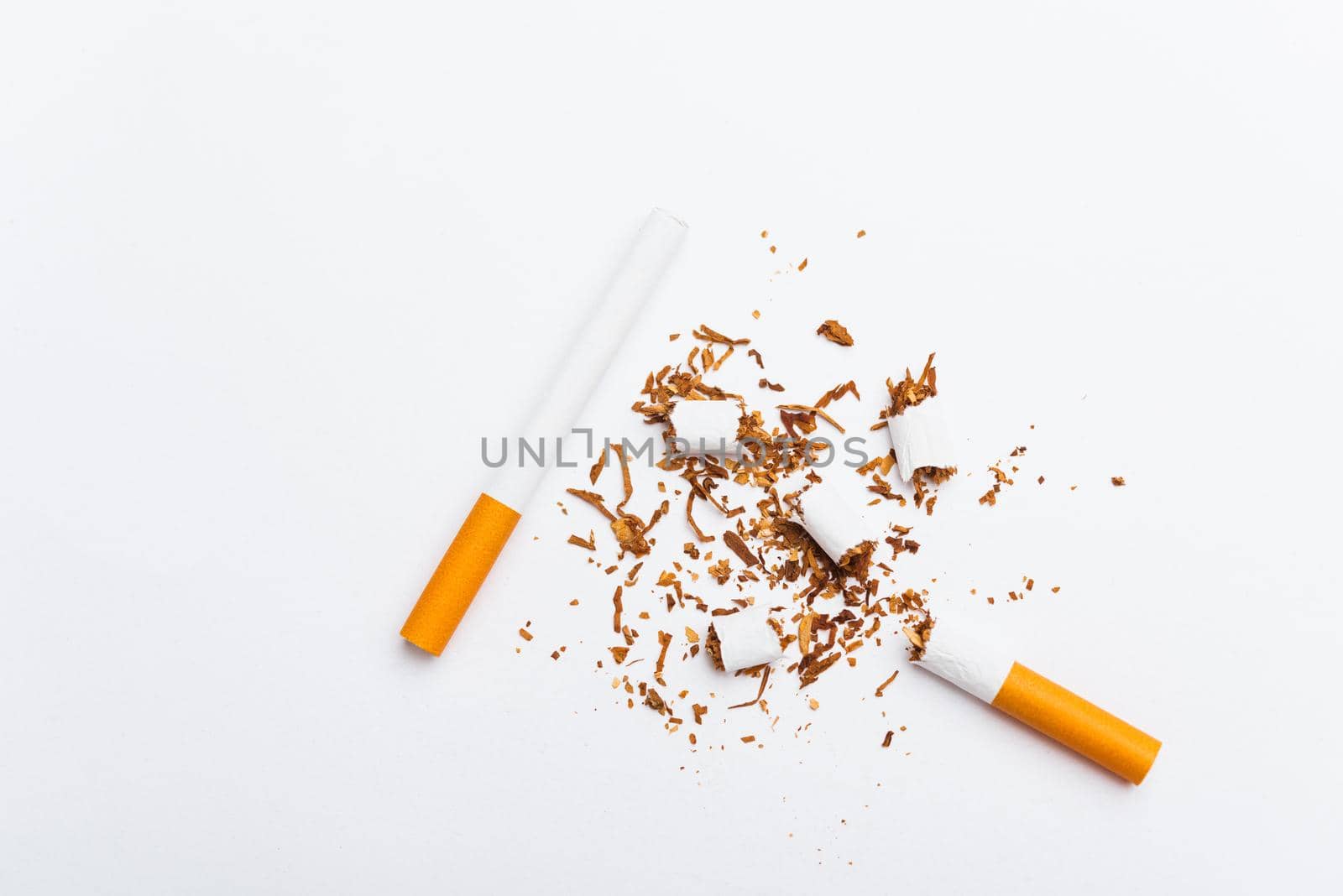 31 May of World No Tobacco Day, no smoking, close up of broken pile cigarette or tobacco STOP symbolic on white background with copy space, and Warning lung health concept