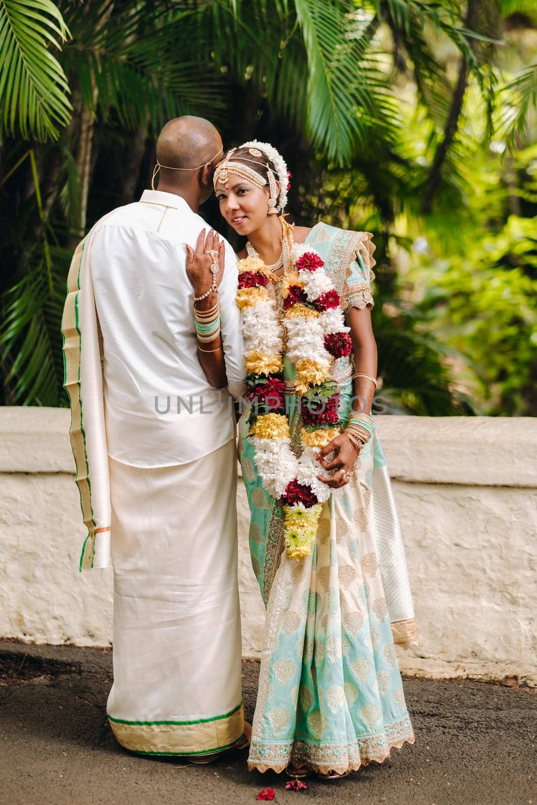 December 8, 2019.Mauritius.The bride and groom in national Mauritian outfits at the Botanical Garden on the island of Mauritius.