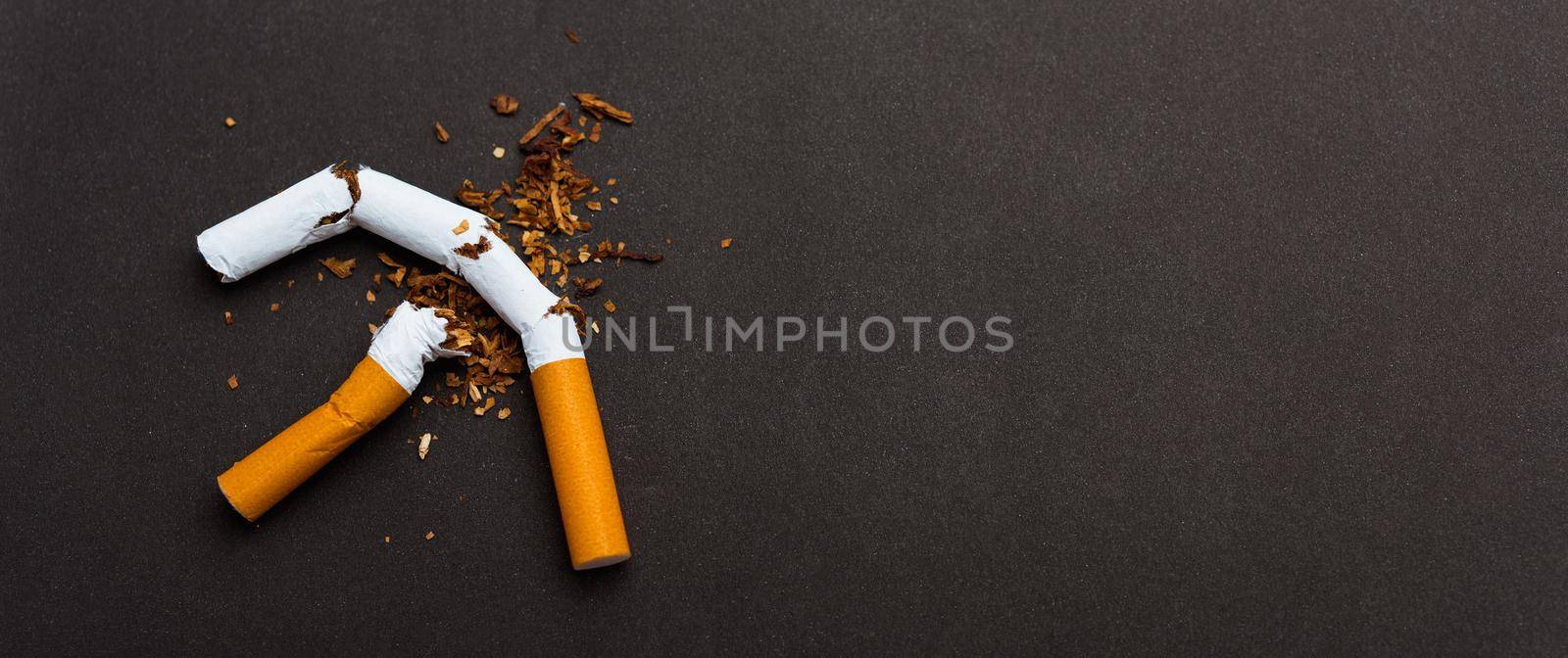 31 May of World No Tobacco Day, no smoking, close up of broken pile cigarette or tobacco STOP symbolic on black background with copy space, and Warning lung health concept