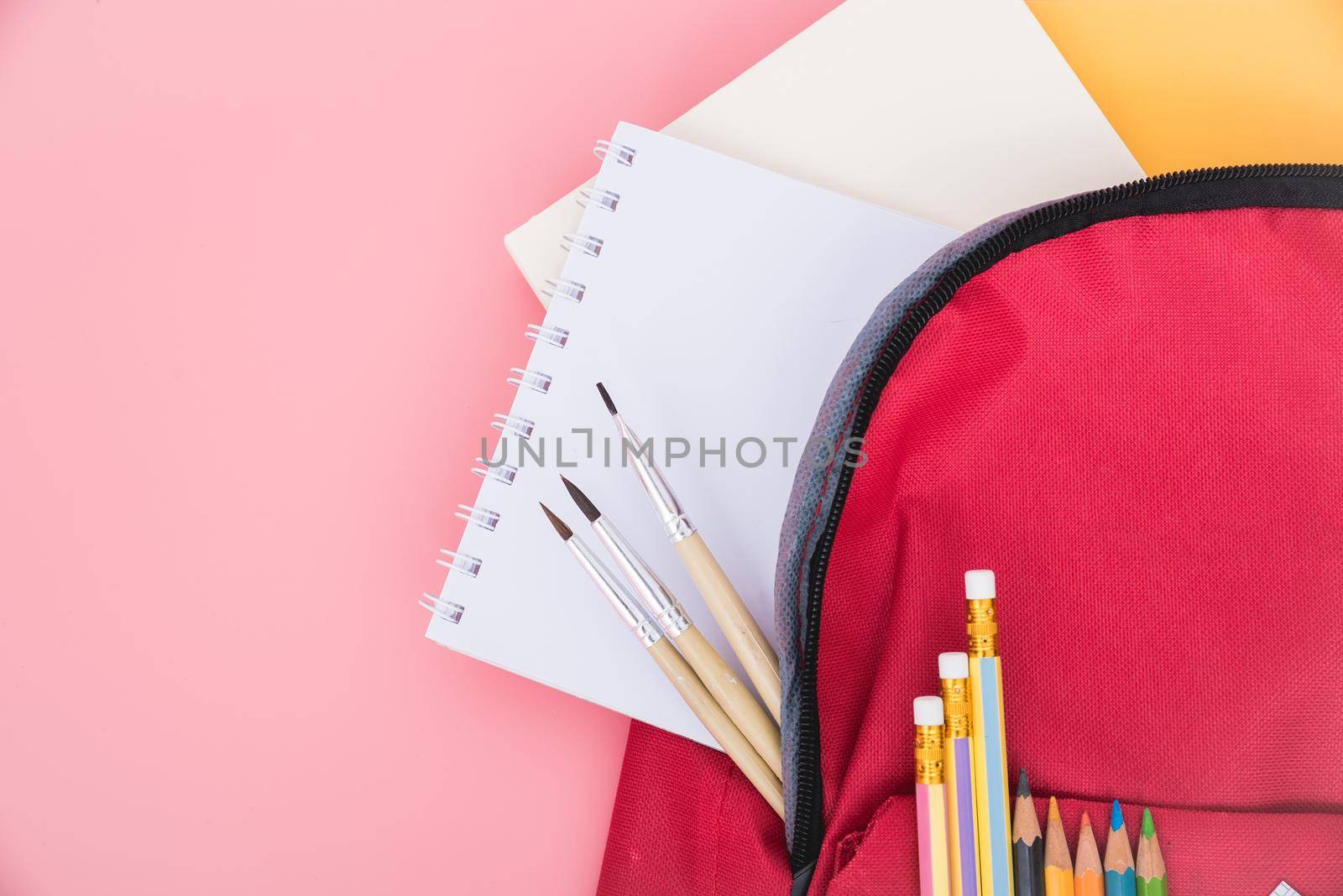 Top view flat lay of red school bag backpack and accessories tools for children education on pink background, Back to school concept and have copy space for use