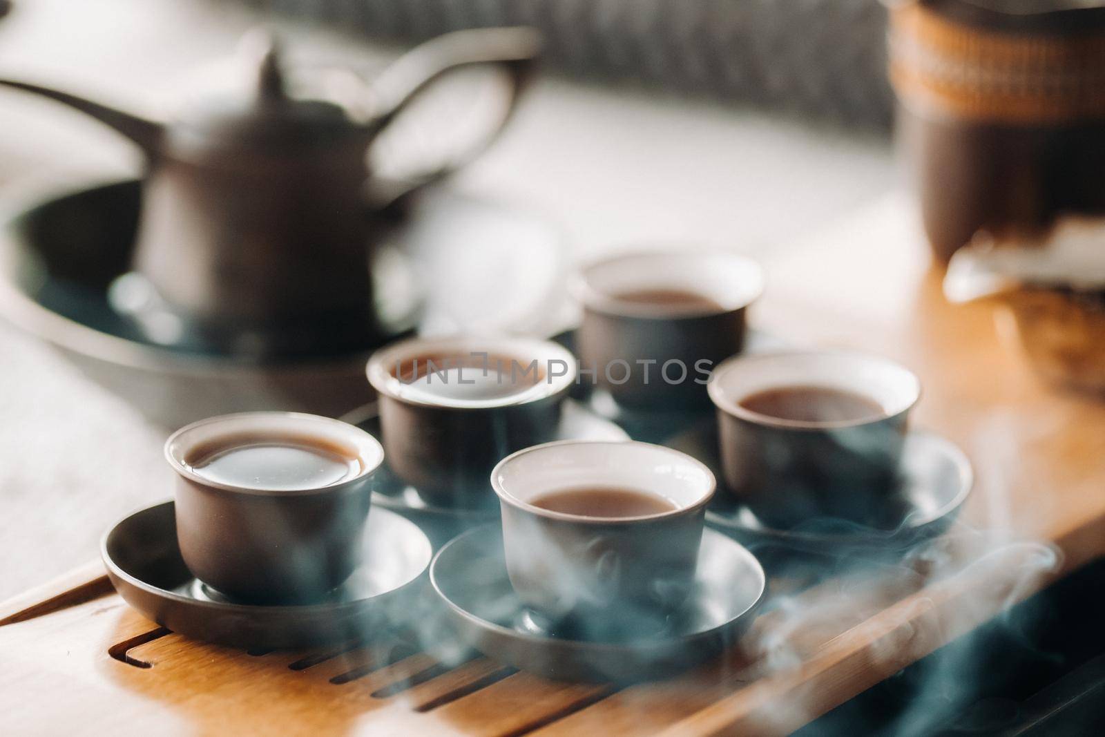 Cups with poured tea before the tea ceremony with incense.