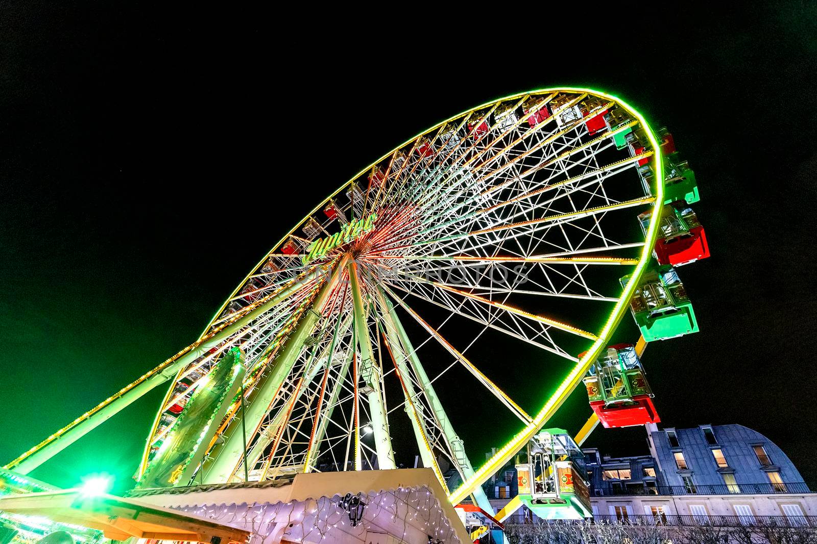 Paris, France - December 21, 2018: Ferris wheel in Christmas market in Tuileries Gardens, Paris, France