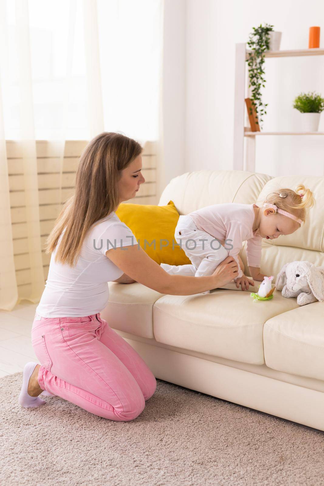 Happy child girl with cochlear implant having fun with her mother - hearing aid for deaf and innovative health technology