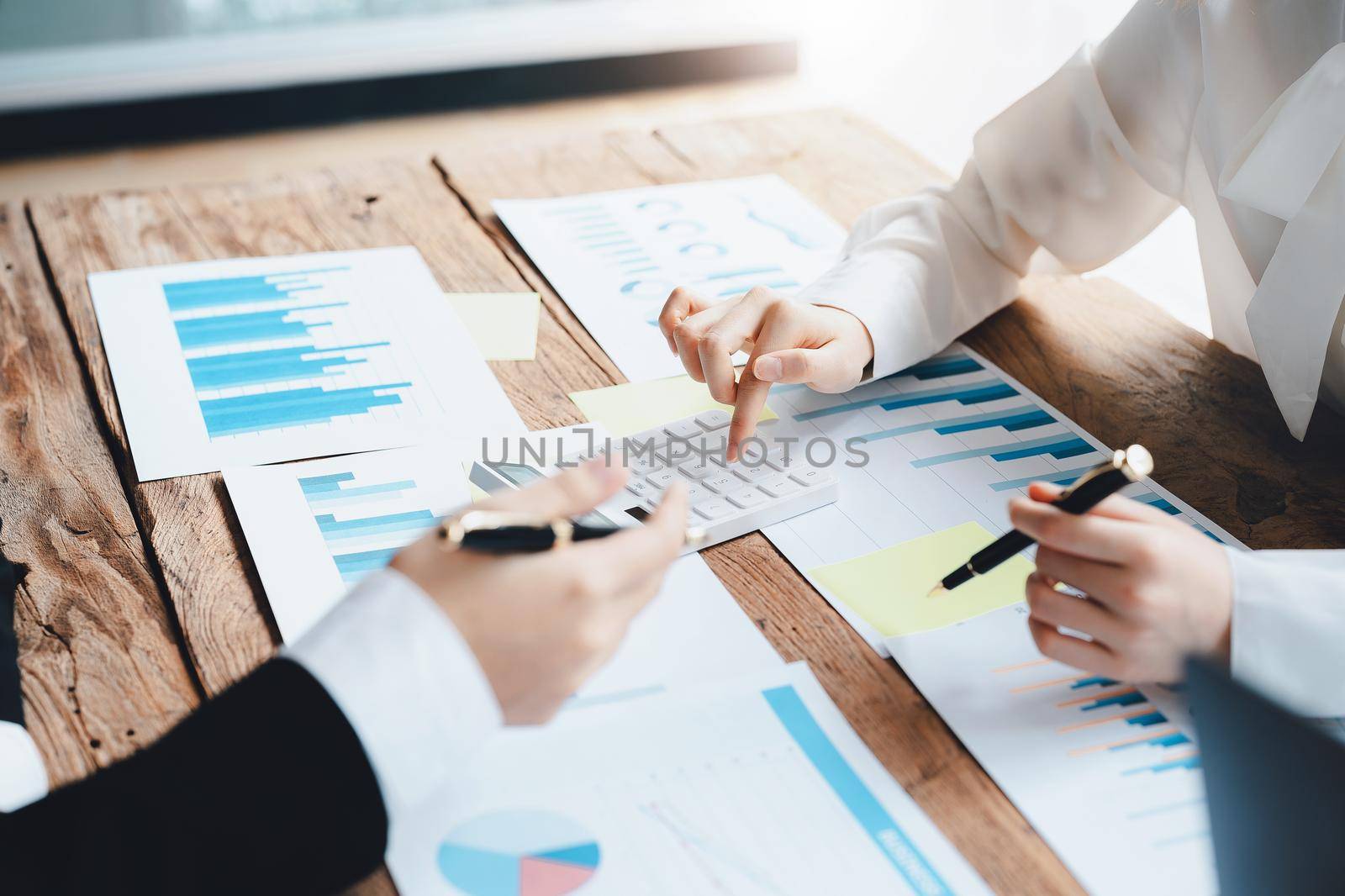 financial, Brainstorming, Data Analysis, Planning, Marketing and Accounting, Economist using calculator to calculate investment documents with partners on profit taking to compete with other companies