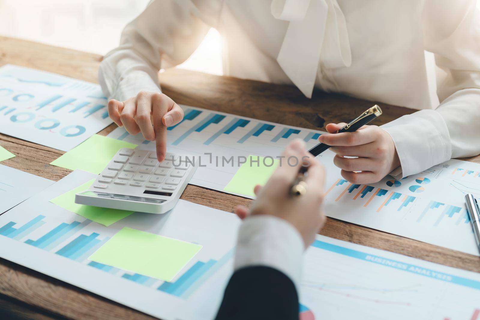 financial, Brainstorming, Data Analysis, Planning, Marketing and Accounting, Economist using calculator to calculate investment documents with partners on profit taking to compete with other companies