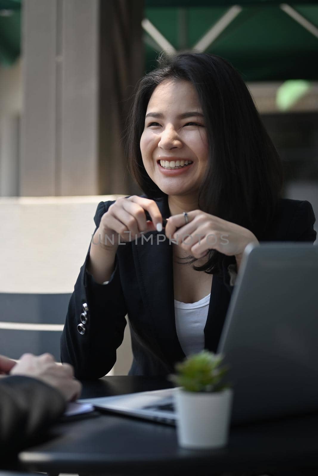 Smiling female manager working with her colleague in modern office.