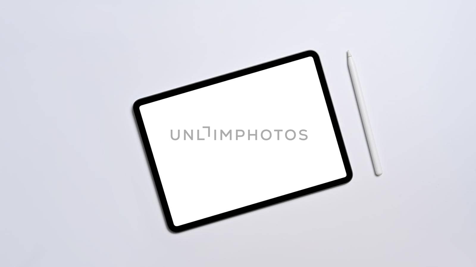 Flat lay digital tablet with empty display and stylus pen on white background by prathanchorruangsak