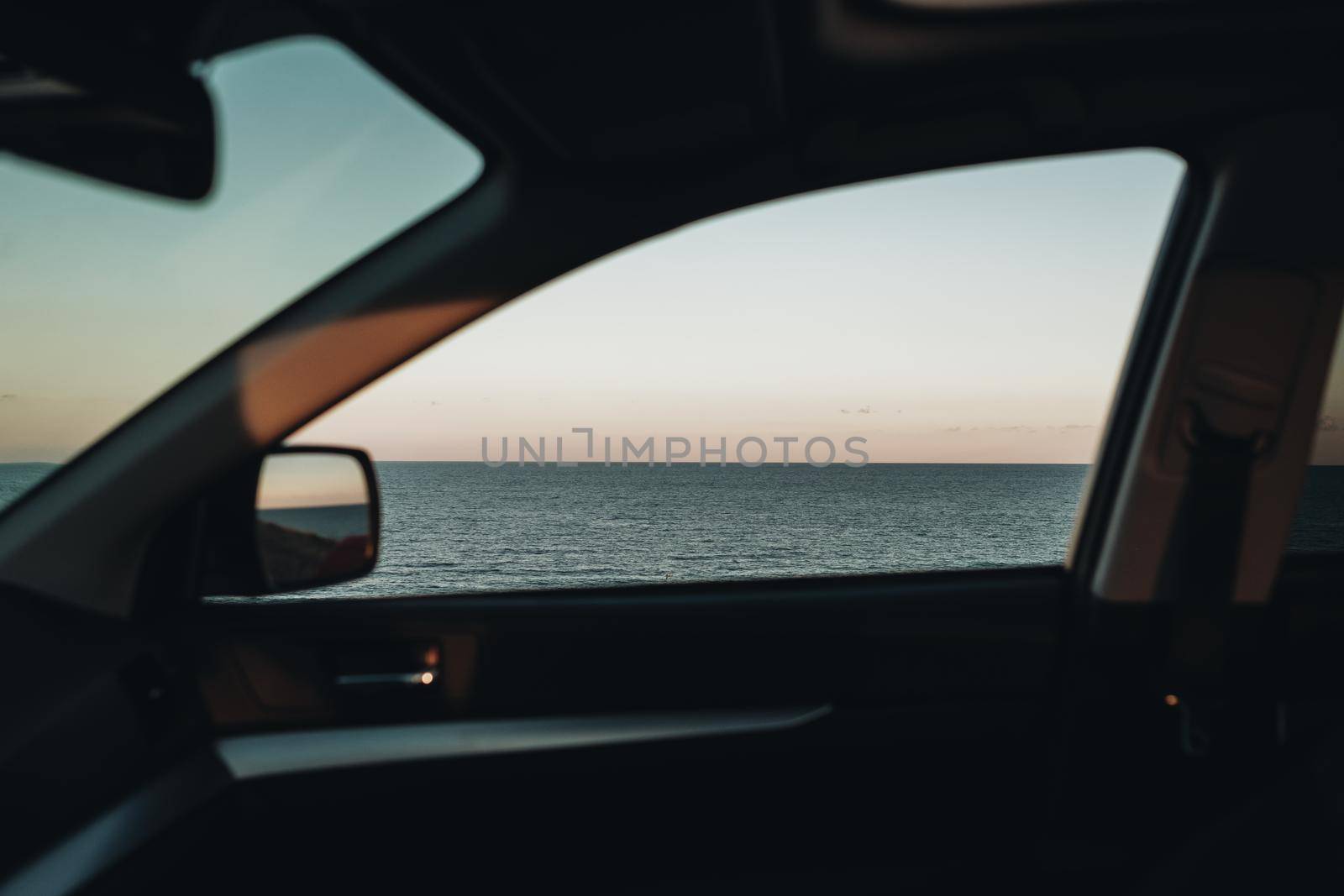 View Through Window of the Car on Sea Landscape at Sunset