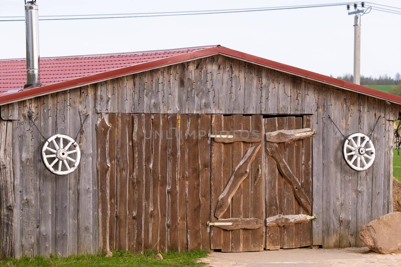 An old barn on the ranch. Large wooden gates and dried wood..