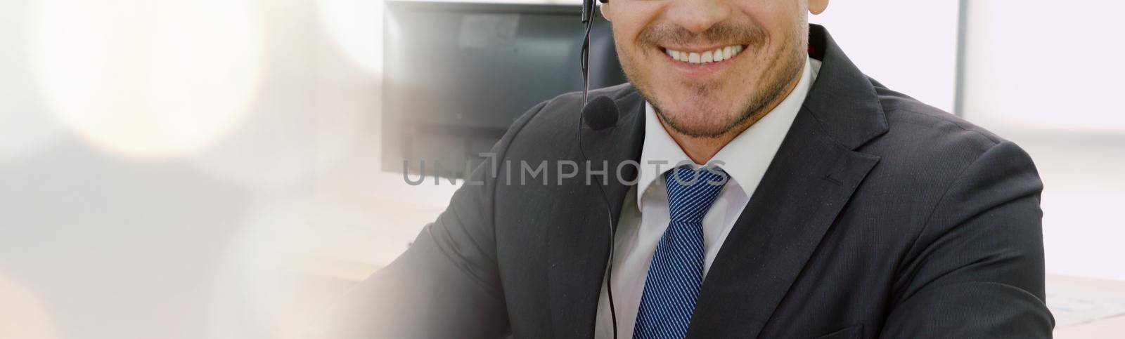Call center or customer support agent in broaden view panorama banner wearing headset while working at office to support remote customer or colleague on telephone video conference call