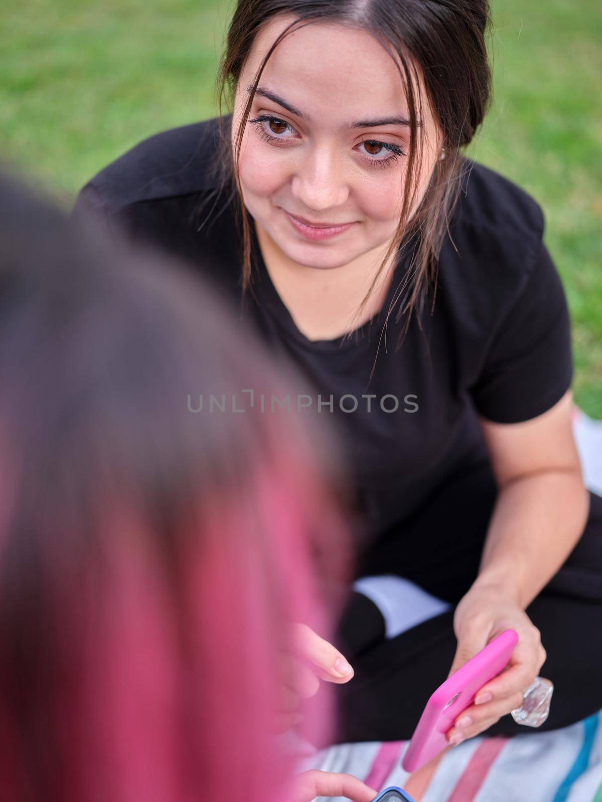 woman in black clothes gazing at her friend and showing her mobile phone by WesternExoticStockers