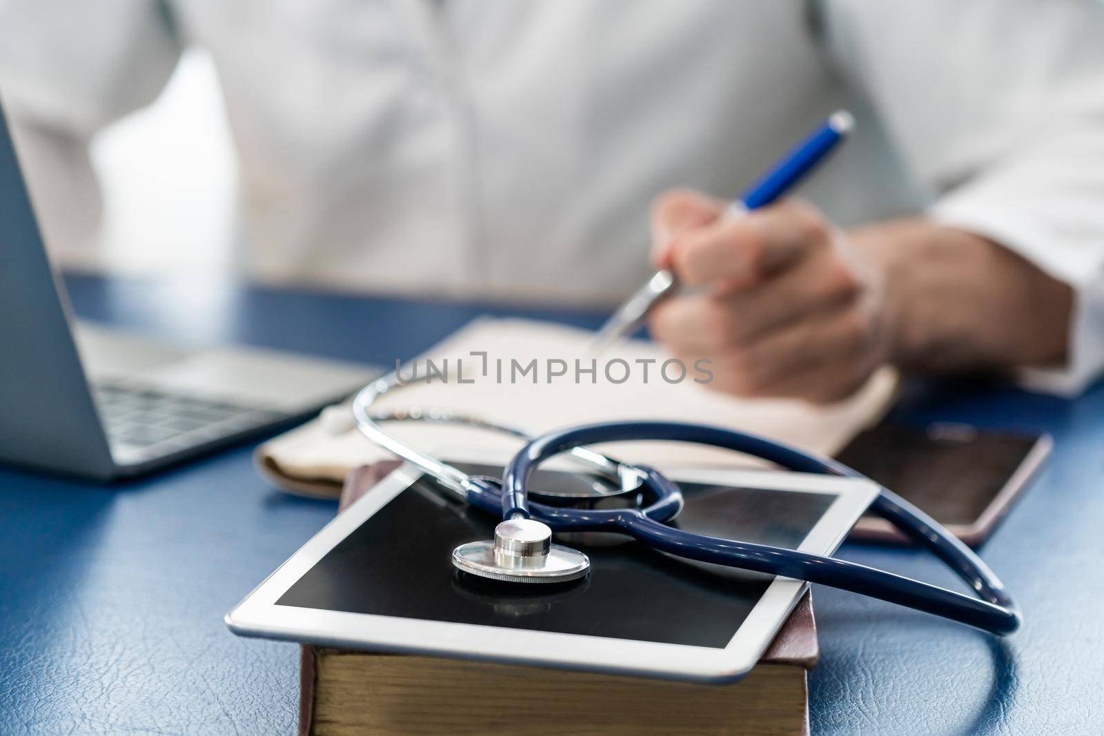 Doctor working in hospital office. Medical healthcare concept.