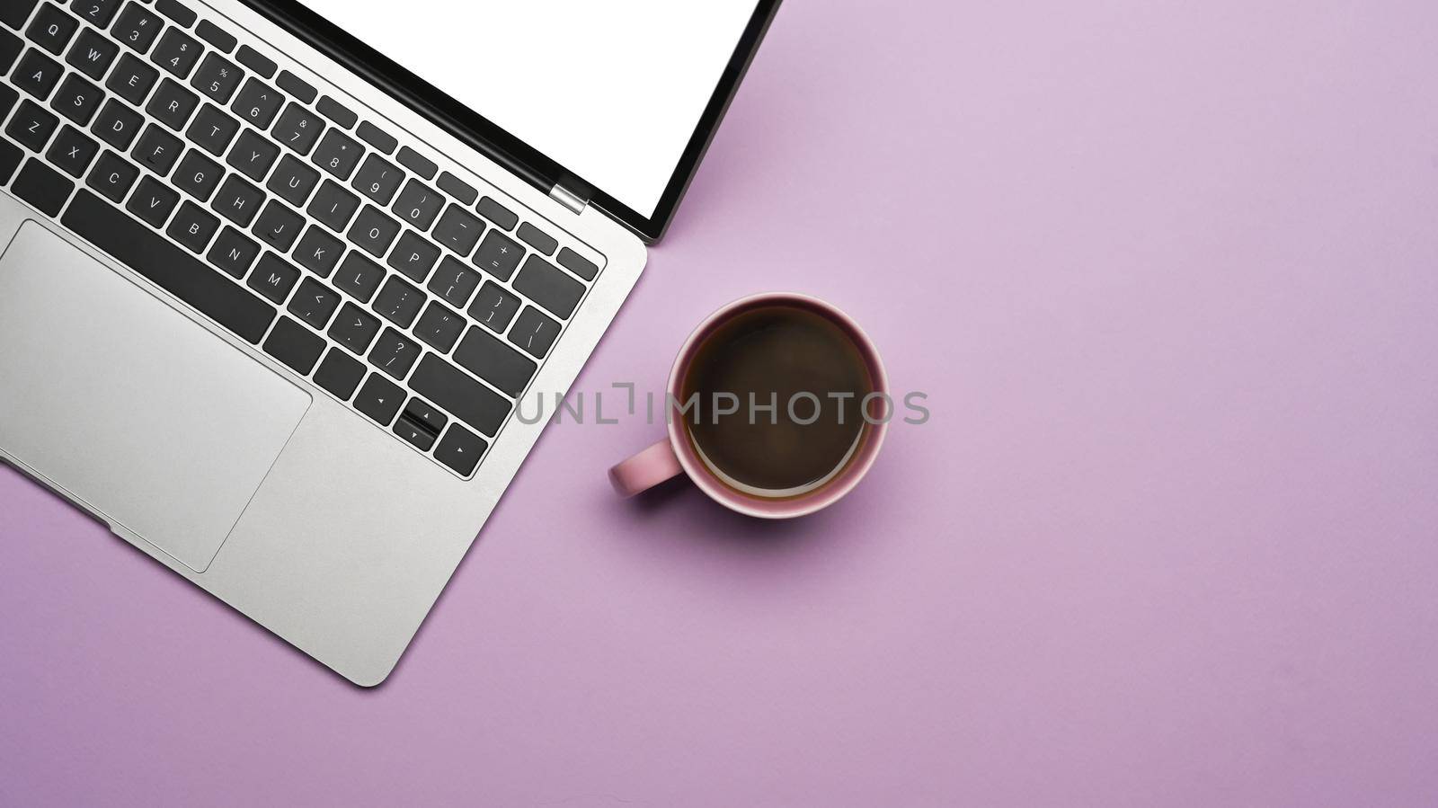 Mockup laptop computer and coffee cup on purple background. Flat lay. by prathanchorruangsak