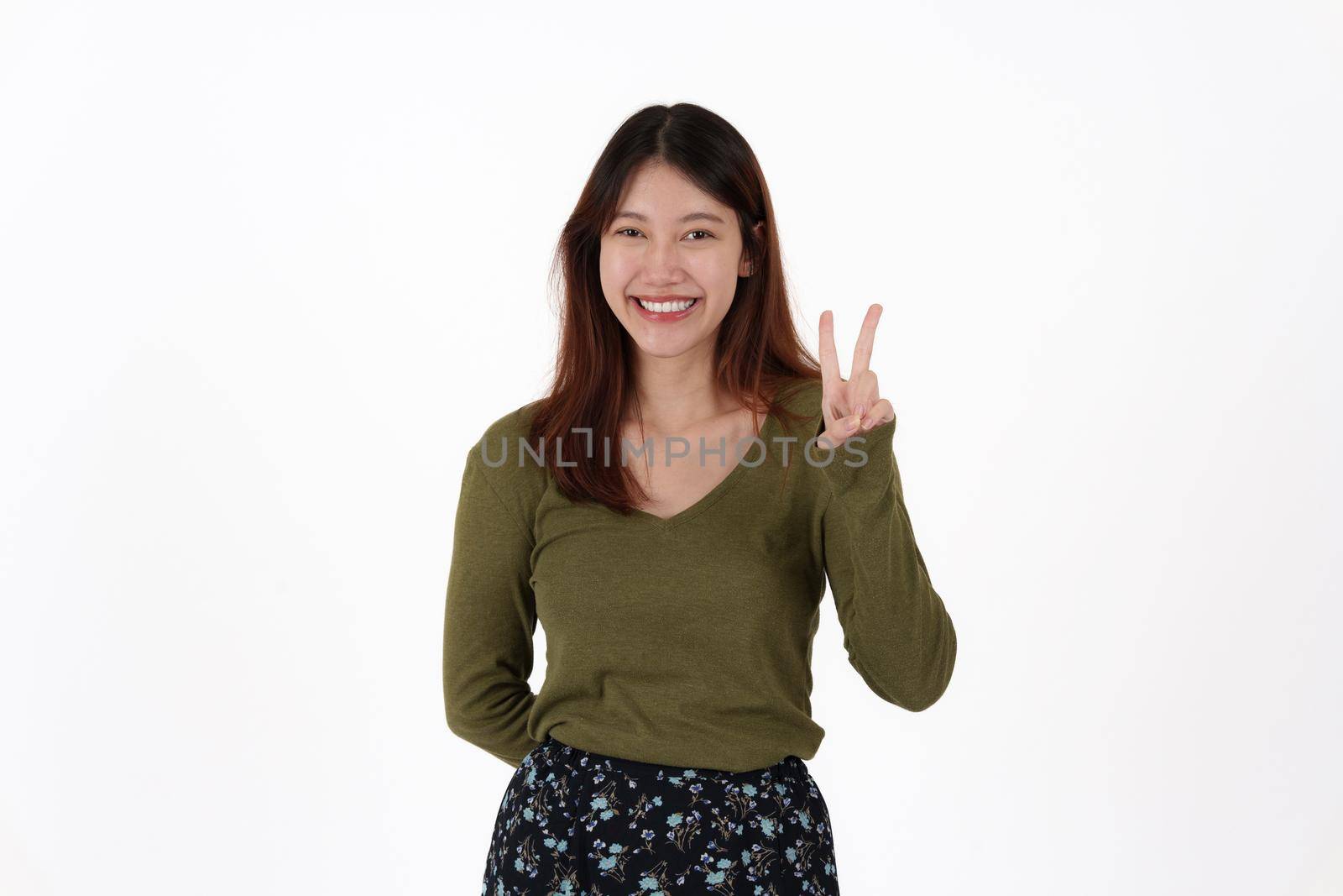 Image of happy young girl standing and Looking camera pointing isolated over white background