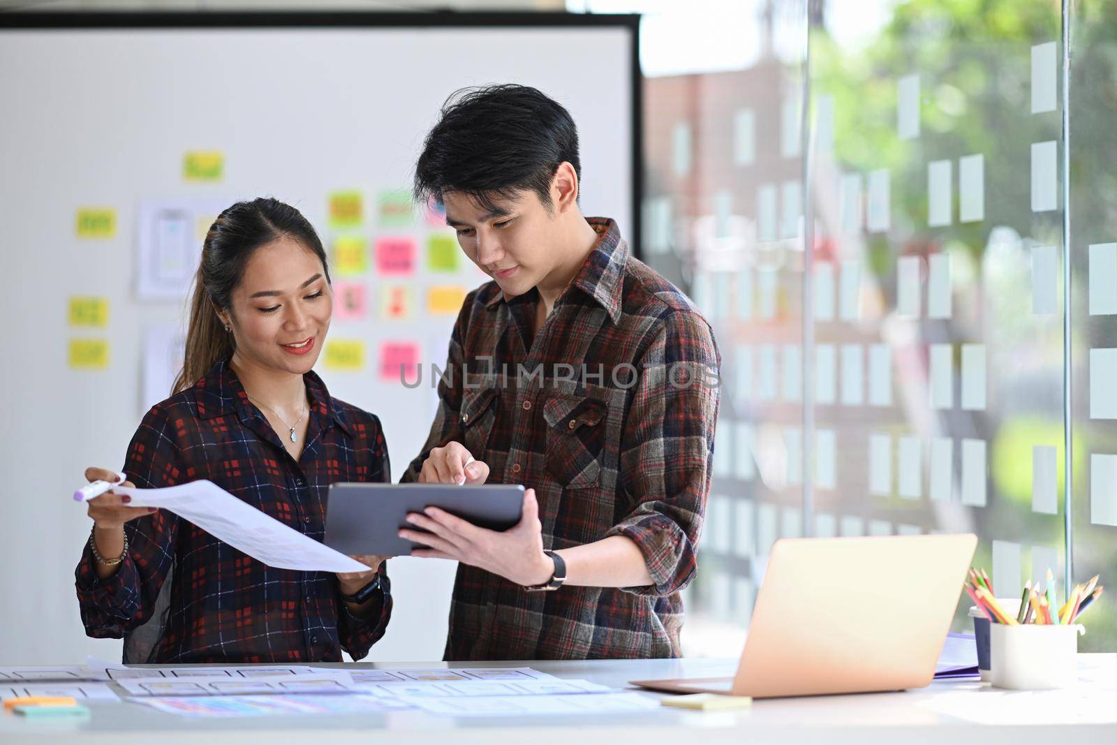 Group of professionals web developers are working on software development using modern devices at creative office.