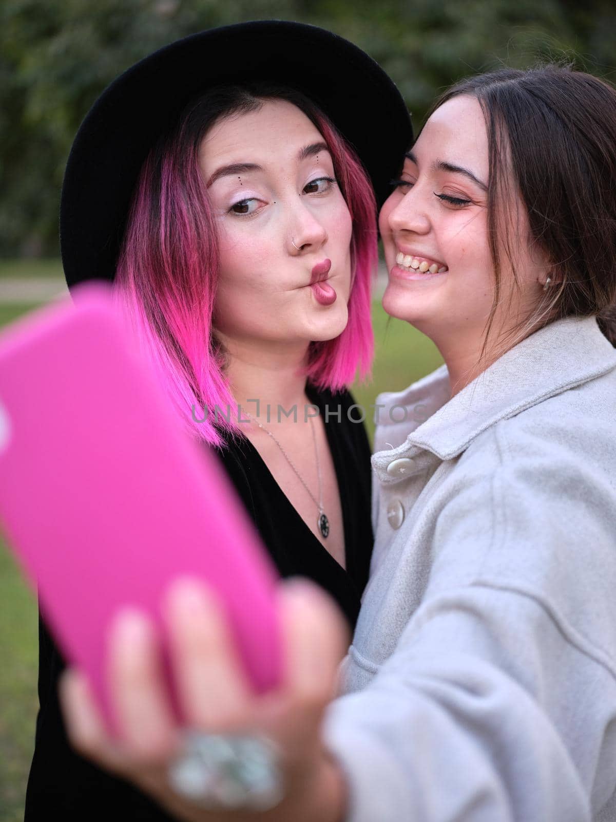 two friends having fun taking a selfie doing lip gestures by WesternExoticStockers