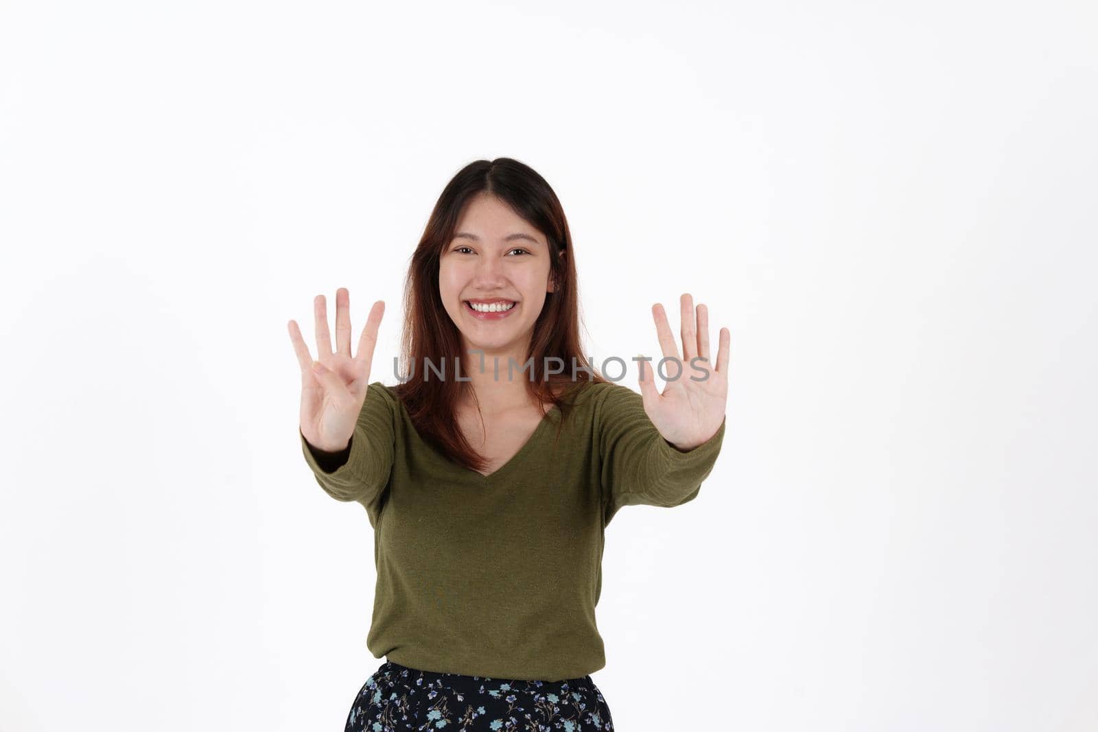 Image of happy young girl standing and Looking camera pointing isolated over white background