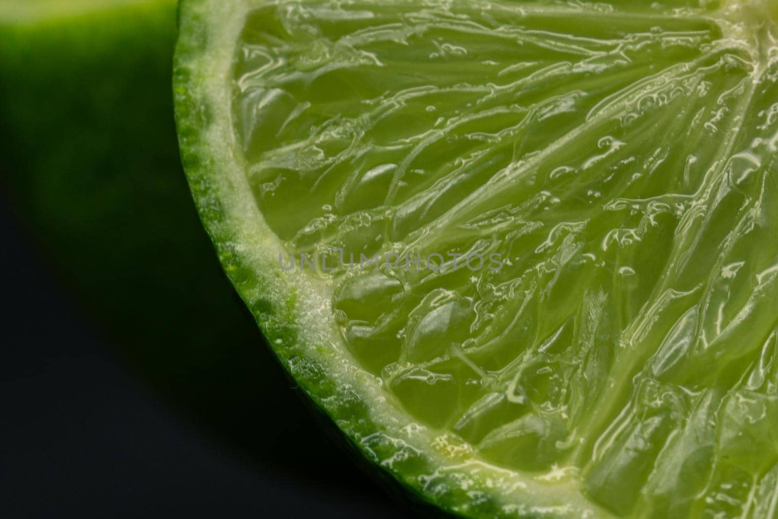 Green lime citruss fruit cutting half macro fiber inside