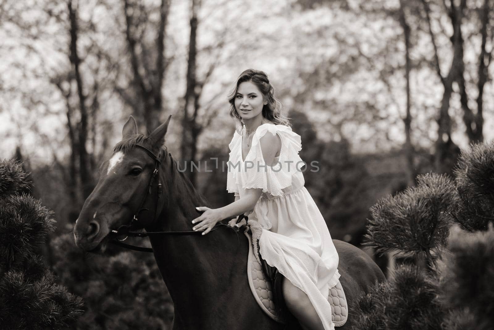 A woman in a white sundress riding a horse near a farm. black and white photo by Lobachad