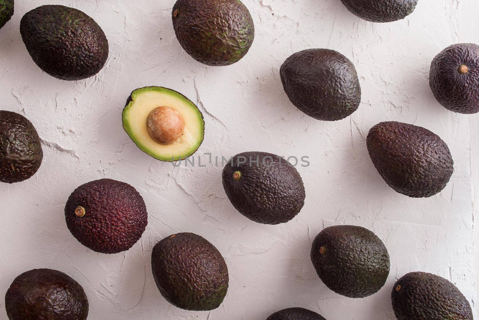 avocado haas with one half cutted. top view. High quality photo