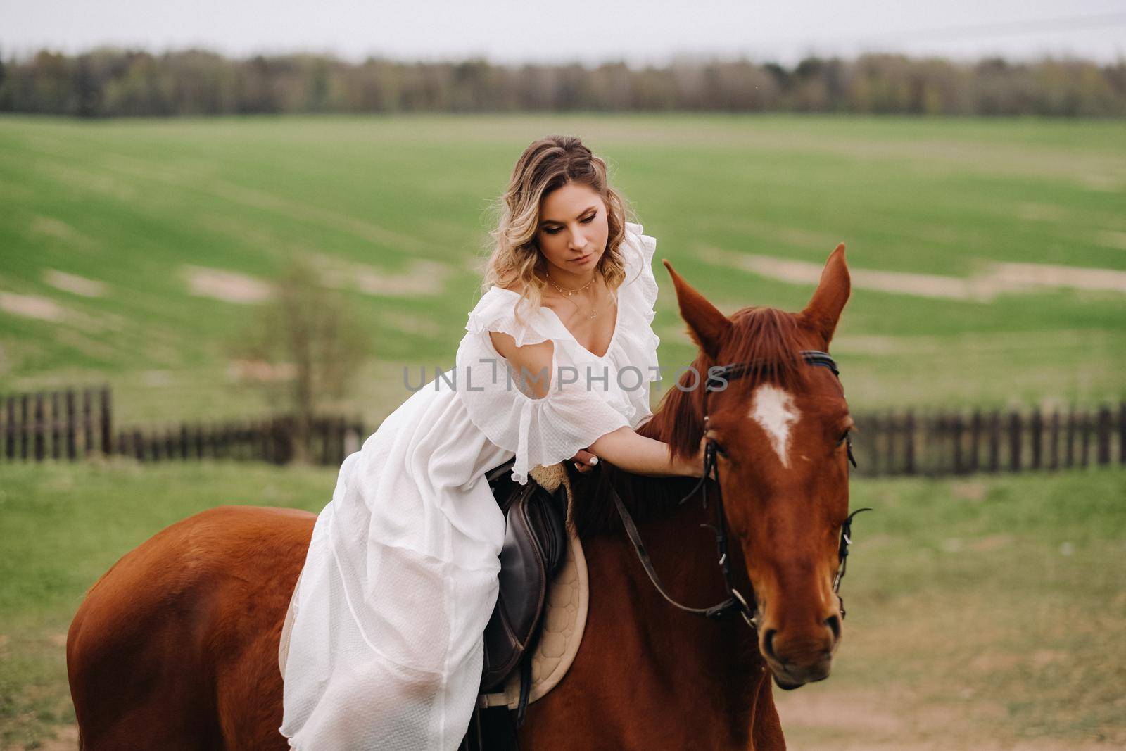 A woman in a white sundress riding a horse in a field by Lobachad