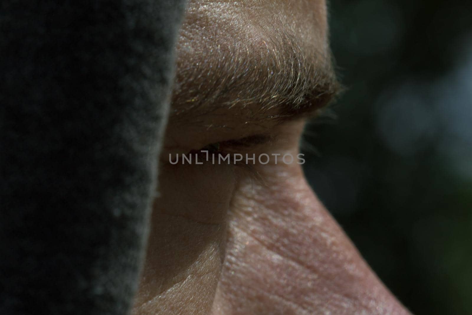 Men  in hood looking straight, skin close up view, face parts eyesbrow, noise, eye