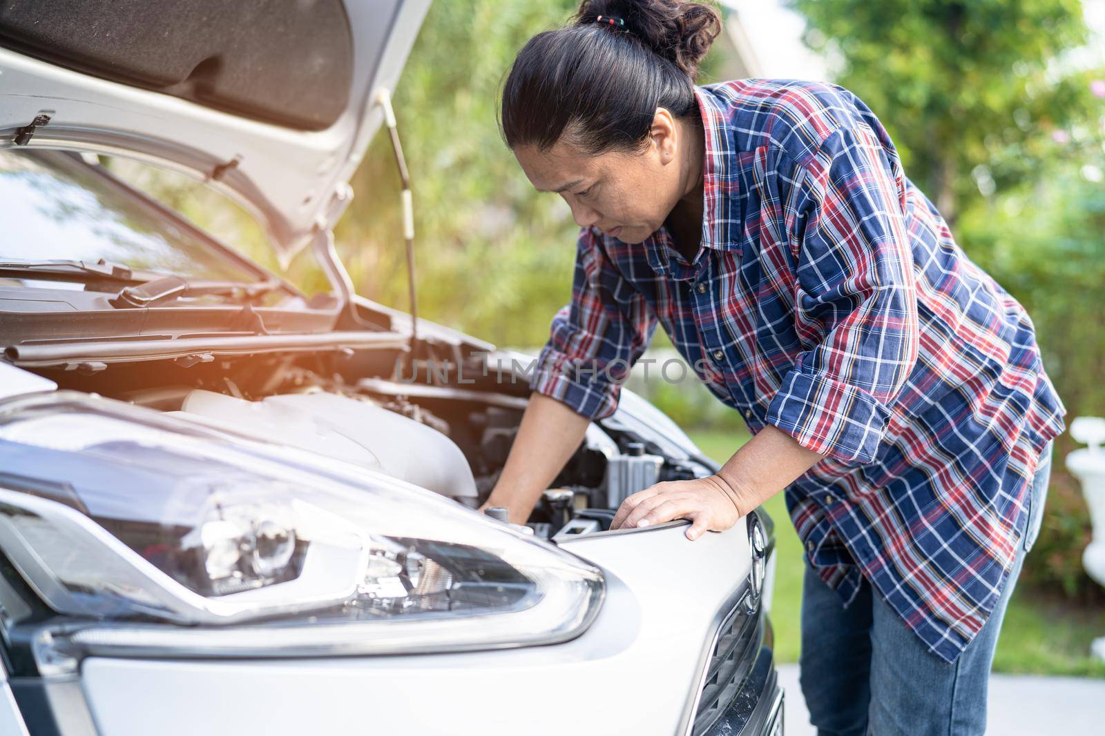 Open hood mechanic engine system to check and repair damage car crash.