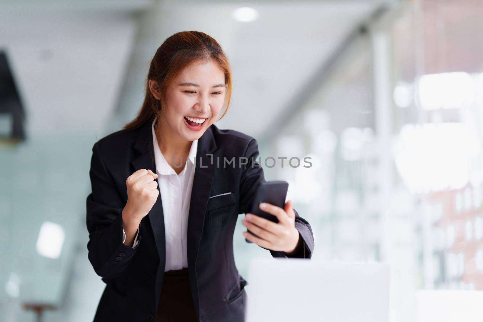 Successful business woman excited when her business growth and good news. Finance concept