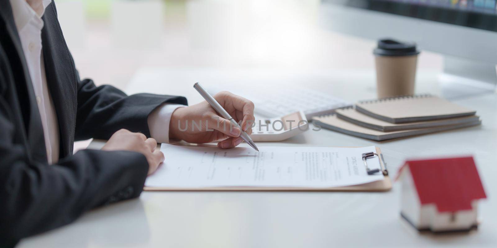 Business woman or broker checking contract agreement paper with customer to sign contract. Real Estate and Agreement concept. by itchaznong