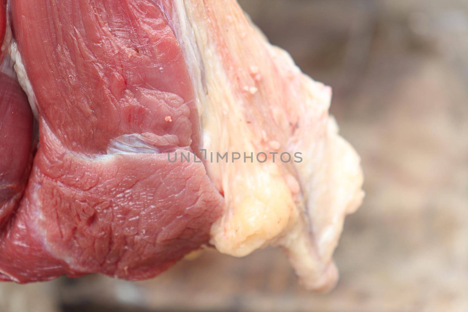 red colored beef closeup with hanging on shop for sell