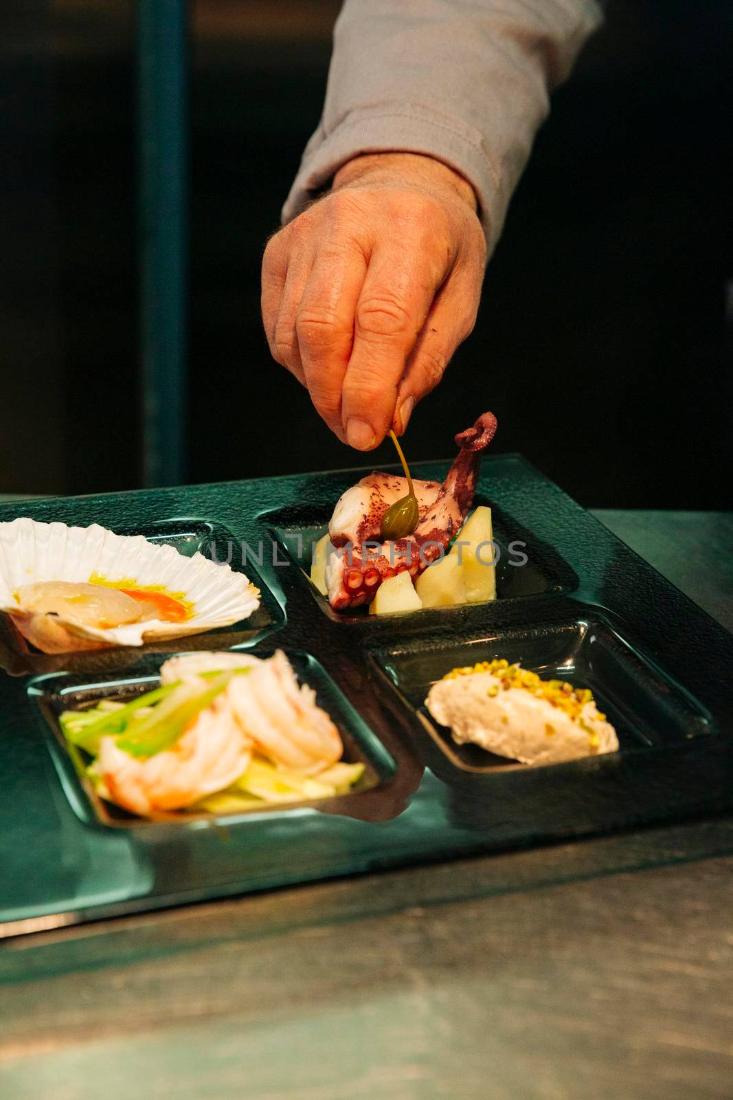 Venetian Cicchetti, small fish dishes as tapas: shrimps salad (gamberetti) , scallops and olive oil (capasanta all'olio di oliva), sea bass and pistachios, octopus and potatoes