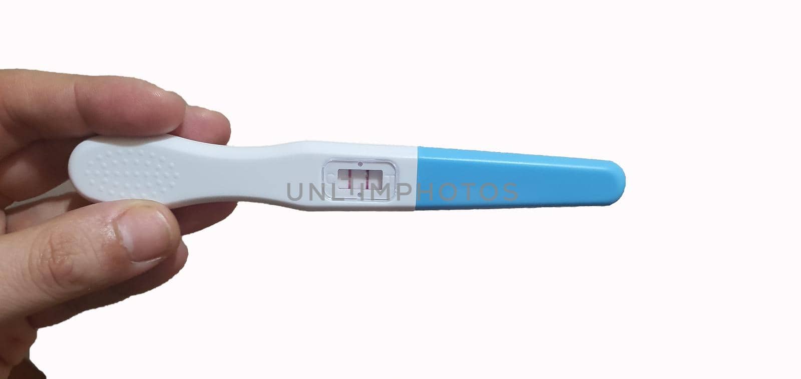 Woman hand holding pregnancy test Female hand showing positive pregnancy test, expecting a baby by barcielaphoto