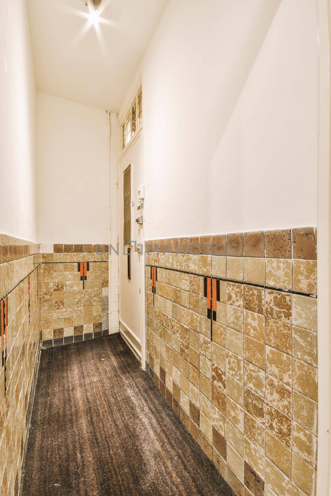 Corridor of contemporary apartment with doorway leading to terrace