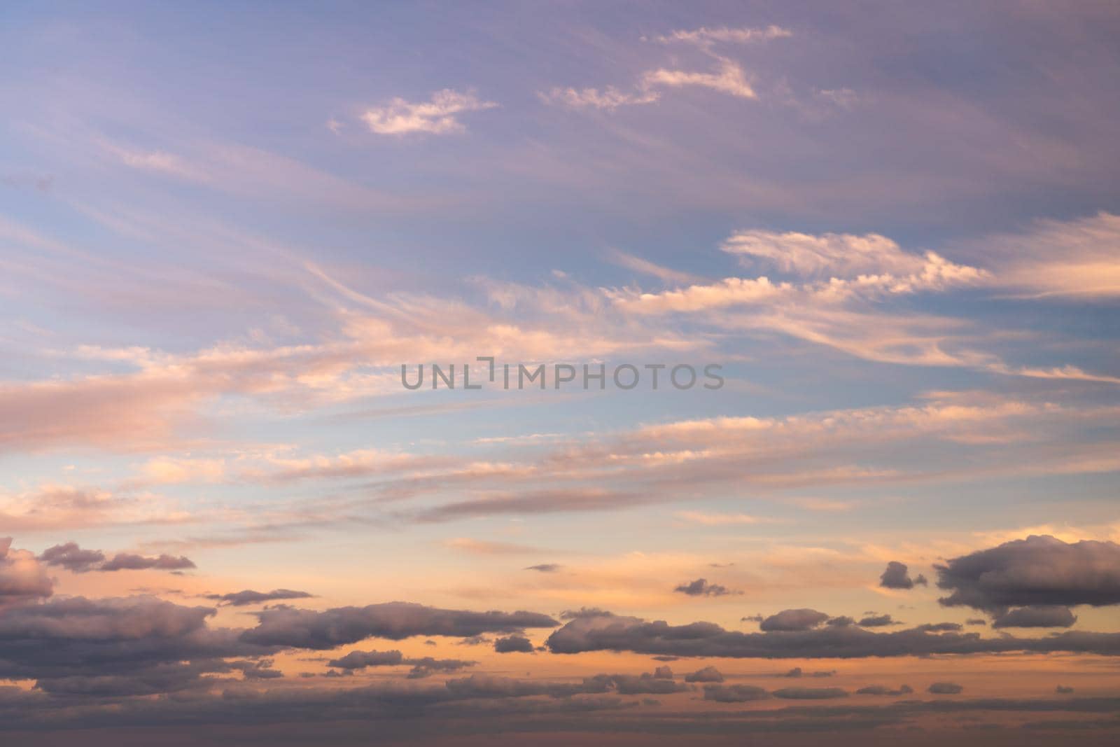 Beautiful sky replacement background with pink, yellow and orange colored clouds on a blue sky backdrop. by lapse_life