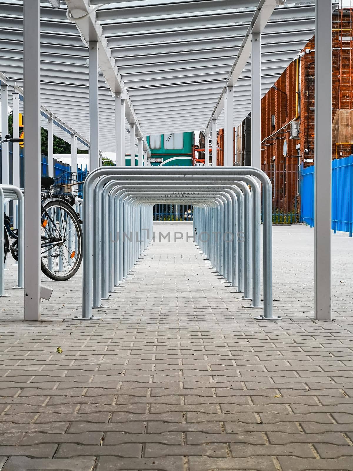 A lot of bike parking places with metal pipes looks like tunnel by Wierzchu