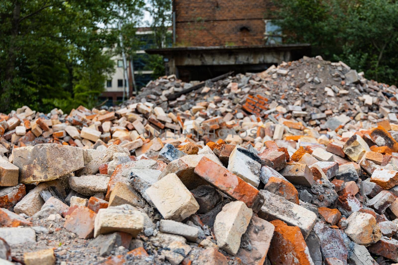 Piles of old red bricks and stones from ruins of old buildings by Wierzchu