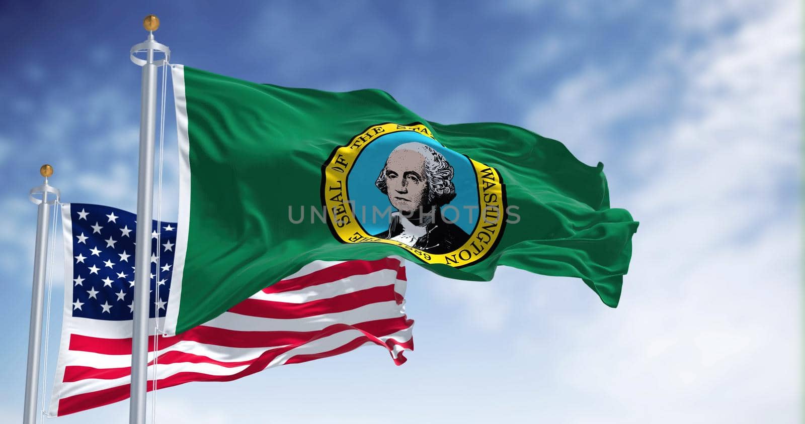 The Washington state flag waving along with the national flag of the United States of America. Washington is a state in the Pacific Northwest region of the Western United States