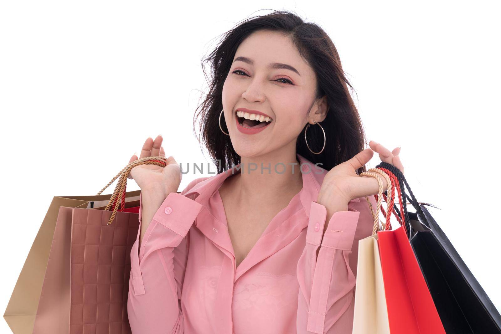 cheerful woman holding shopping bag isolated on a white background by geargodz