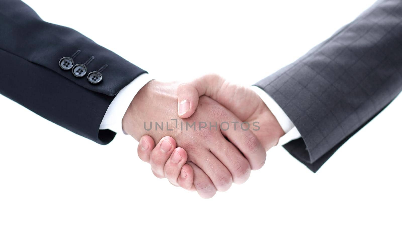 Close-up partial view of two businessmen shaking hands, business concept