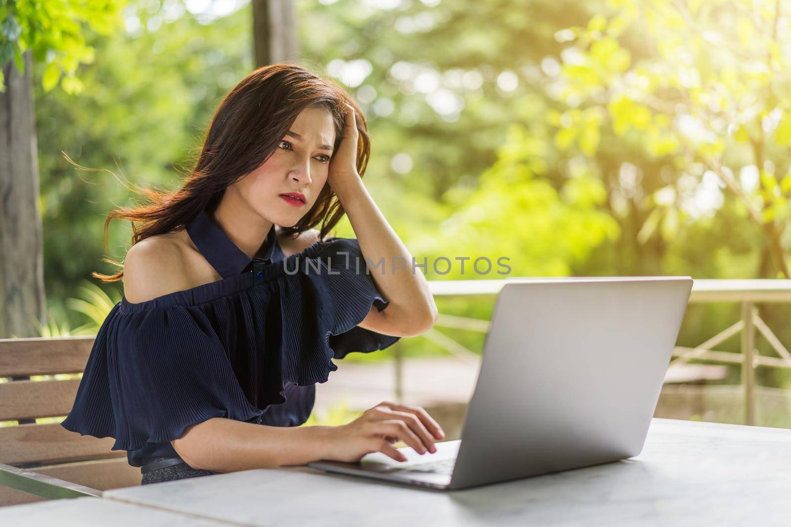 stressed woman using laptop computer by geargodz
