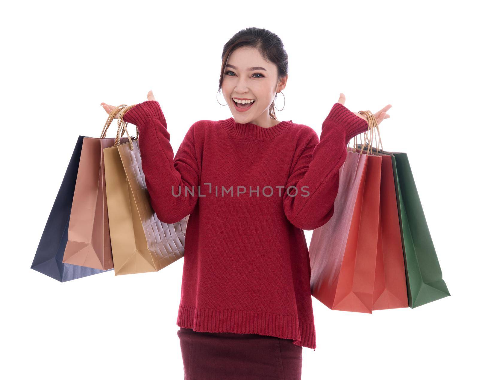 cheerful young woman holding shopping bag isolated on white background by geargodz