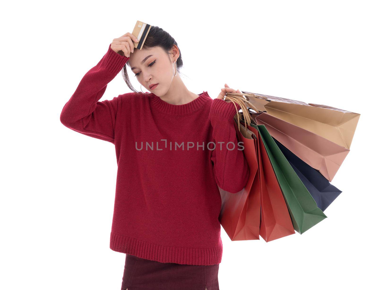 stressed woman holding credit card and shopping bag isolated on white background by geargodz