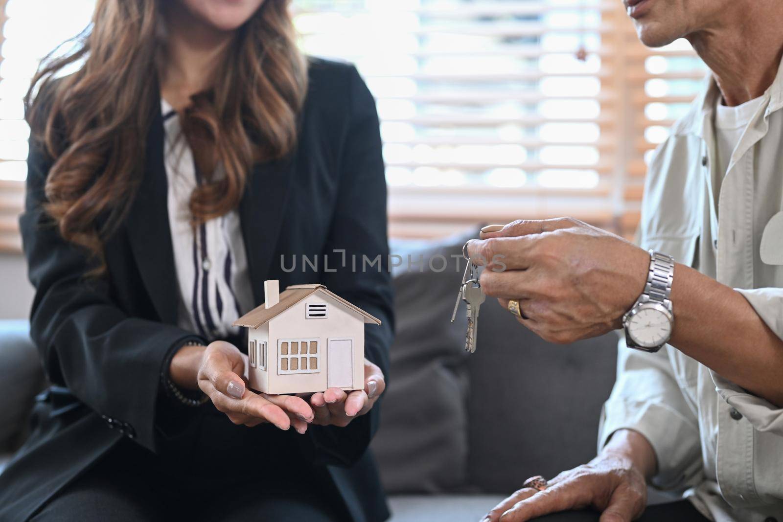 Cropped image of senior owners making sale purchase property with real estate agent.