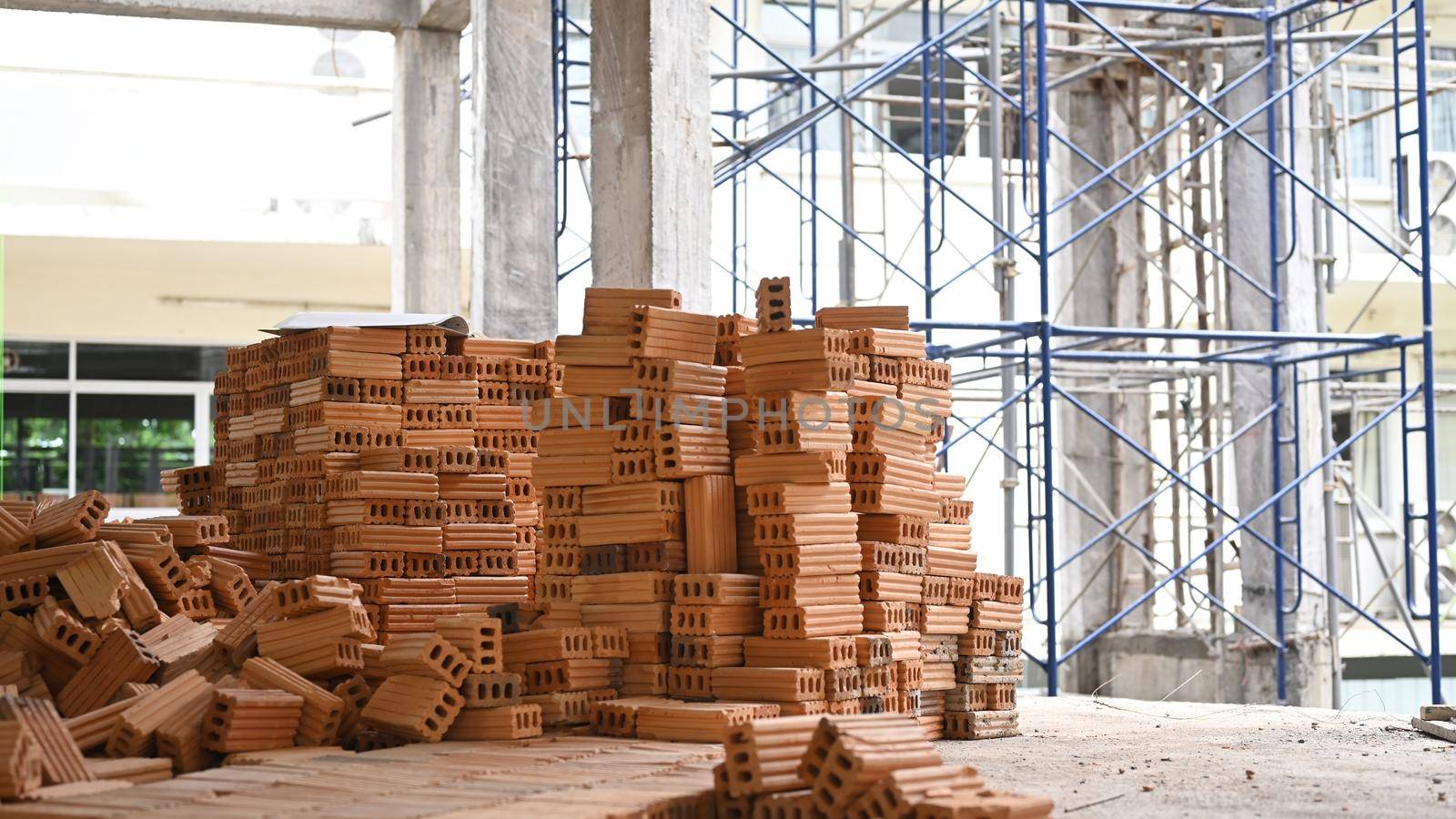 Pile of new bricks at the construction site. Concept of repair and building materials.