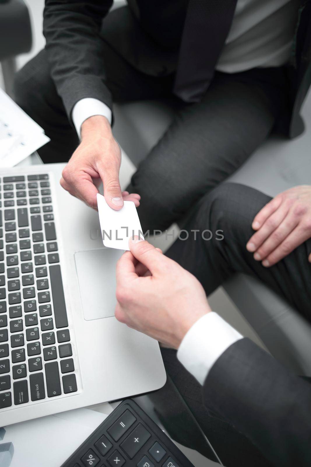 close up.business people exchange their business cards.concept of partnership