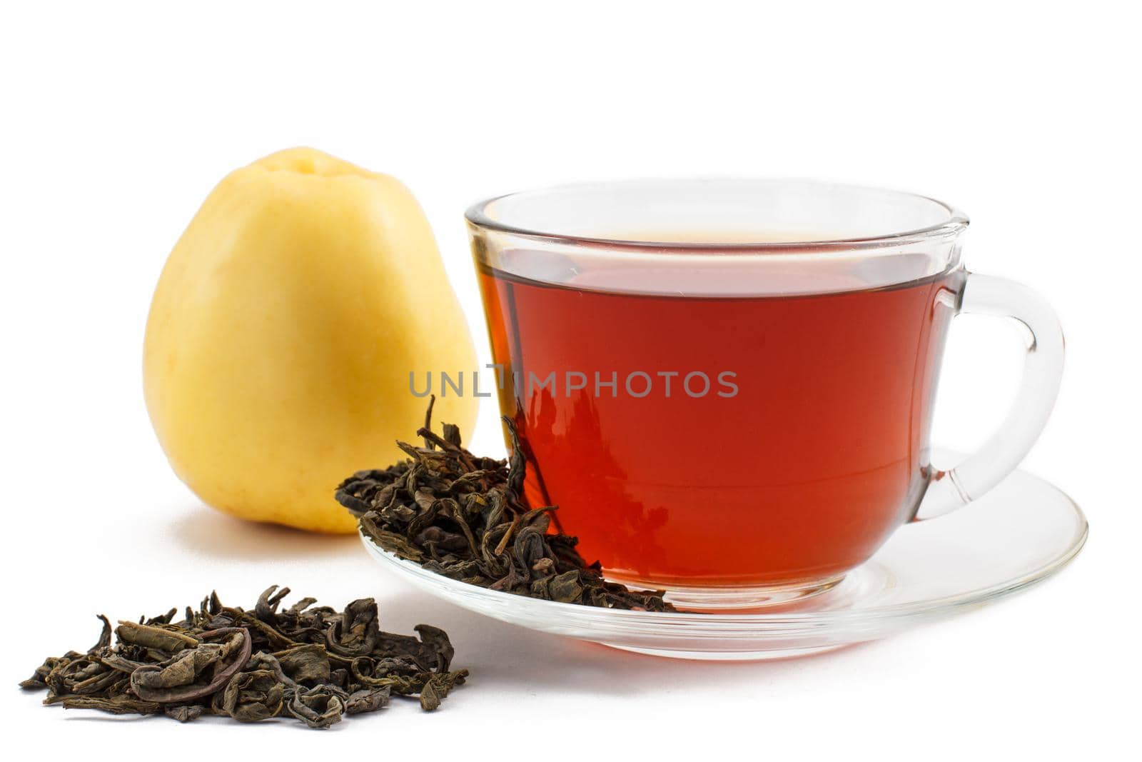 Glass cup of black tea on saucer with dry leaves of green tea and apple on white isolated background