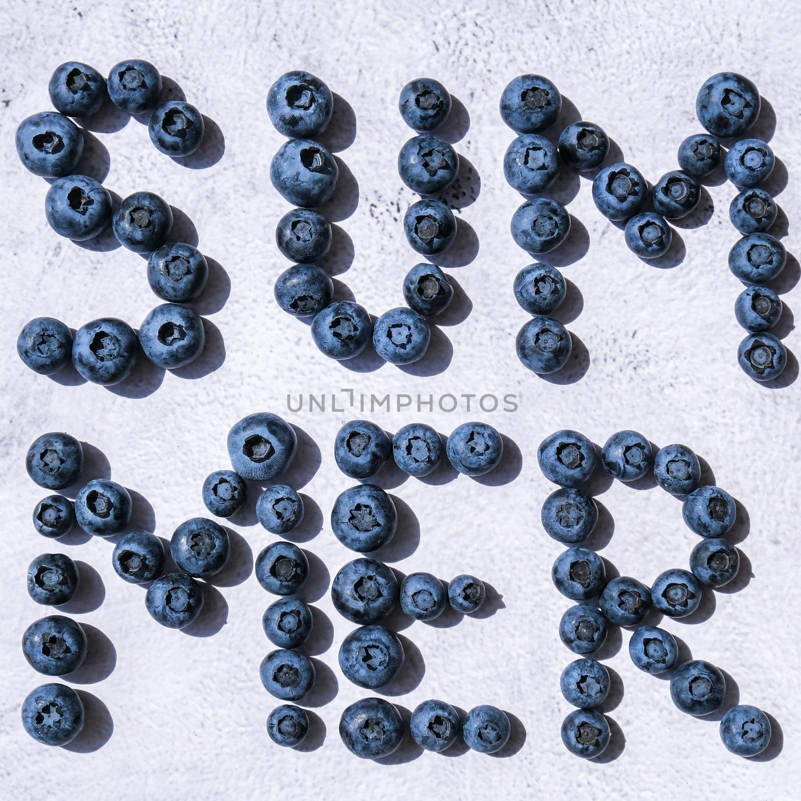 Summer inscription lined from blueberries. Fruits and berries, vegetarian and healthy eating concept. Summer text created from blueberries. Superfood by anna_stasiia